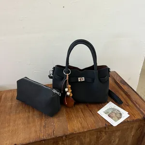 Black leather handbag set with shoulder strap and chic turn lock design for daily wear style.
