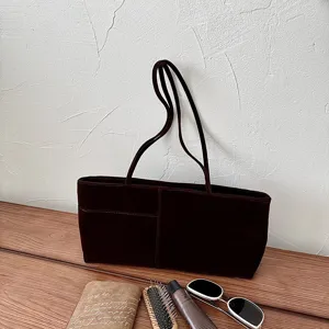 Brown velvet shoulder tote bag detail shot with front pocket and dual straps for daily commuting.