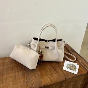 Elegant beige niche design shoulder bucket bag and pouch set for chic autumn daily commuting.