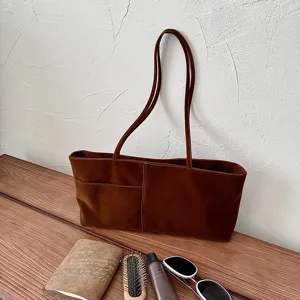 Brown suede shoulder bag detail, casual daily tote with front pocket and dual straps.