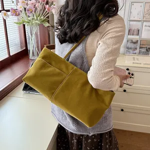 Velvet shoulder bag detail showing soft fabric texture, spacious interior and elegant everyday look.