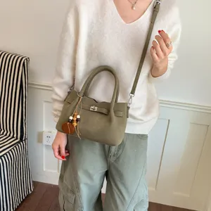 Olive green bucket bag for women, chic suede crossbody tote with wooden bead pendant stylish.