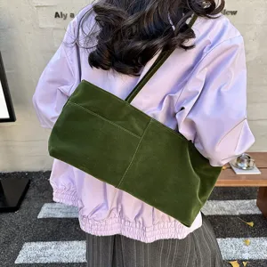 Green velvet shoulder bag detail, stylish underarm tote bag with front pocket design.