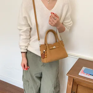 Stylish brown crossbody shoulder bag for women, chic design with turn-lock and chic charm.