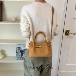 Chic leather crossbody shoulder bag for women, stylish daily commute handbag with top handle.