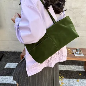 Green velvet shoulder bag detail view, casual large capacity commuter tote handbag for women.