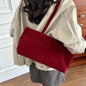 Detail view of the red velvet shoulder bag, large capacity casual tote for daily commute.
