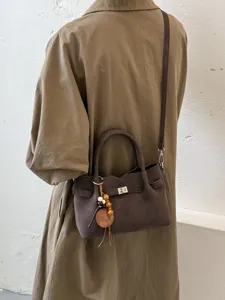 Chic brown shoulder crossbody bag with turn-lock and charm for women autumn winter