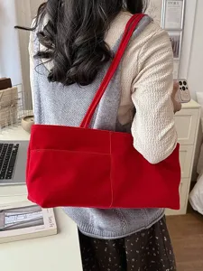 Casual red velvet shoulder bag for women, large capacity handbag and stylish commuter underarm bag.
