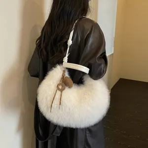 White faux fur hobo shoulder bag for women, stylish fluffy crescent underarm bag, winter fashion.