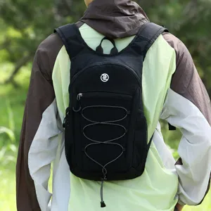 Closeup of black outdoor backpack featuring front elastic bungee cord and mesh side pockets.