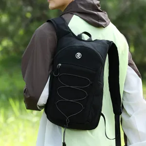 Detail view of black lightweight outdoor backpack with front bungee cord and breathable straps.