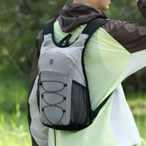Lightweight outdoor backpack detail, grey hiking daypack with bungee cord for travel.