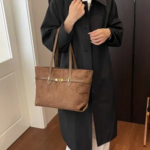 Large capacity brown women shoulder tote bag featuring stylish metallic lock detail.