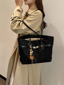 Women large capacity tote bag fashion casual shoulder bag with belt and tassel pendant.