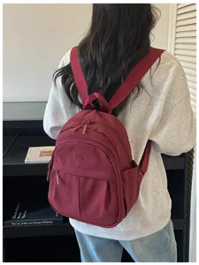 Casual large capacity wine red backpack detail view, stylish korean style daily travel school bag.