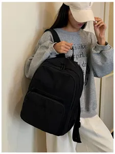 Casual black backpack for women, multi-pocket school bookbag for outdoor travel and daily use.