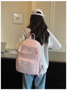 Women casual pink backpack detail view, multi-pocket school travel rucksack for daily wear.
