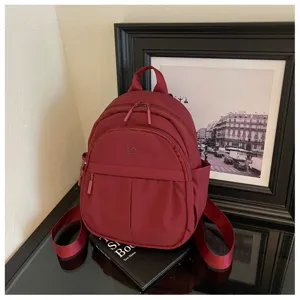 Casual burgundy backpack for women, stylish Korean style daypack with multiple pockets.