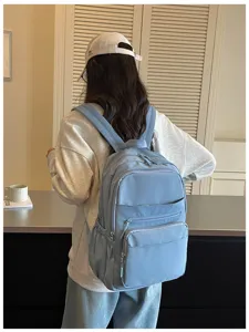 Casual blue multi-pocket school backpack detail view, comfortable straps and durable fabric.