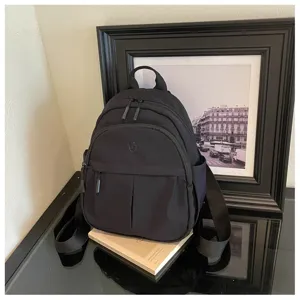 Casual black backpack for women, large capacity minimalist travel school daypack bag.