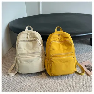 Casual multi-pocket canvas backpack detail view, featuring durable dual-color daily school bags.