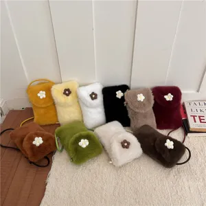 Plush crossbody phone bag for women, soft furry shoulder bag with cute daisy flower decoration.