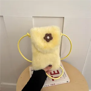 Plush crossbody phone bag, soft yellow furry shoulder bag with cute brown flower detail.