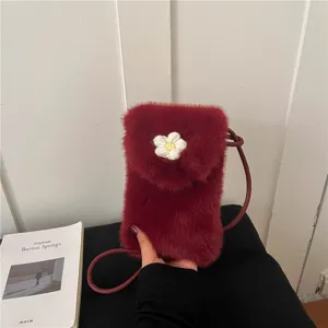 Close-up detail of fluffy burgundy mini crossbody phone bag featuring a cute flower accent.