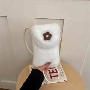 White plush phone bag with knit flower, fuzzy crossbody bag for women, cozy winter accessory.