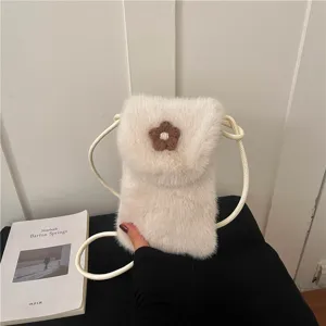 Detailed view of white plush mini crossbody phone bag featuring a cute brown flower decoration.