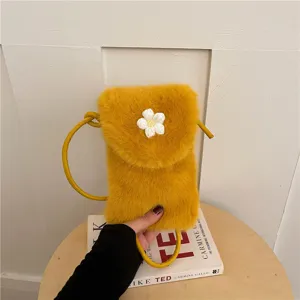 Yellow plush phone bag detail shot, cute white flower decor, soft crossbody strap style.