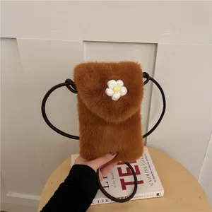Detailed view of the brown plush phone bag with cute white crochet flower and strap.
