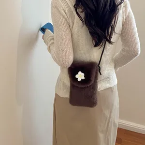 Detailed view of the autumn winter brown plush crossbody phone bag with flower decor.