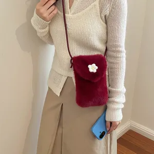 Cute fuzzy phone bag detail shot, autumn soft plush crossbody bag with sweet floral accent.
