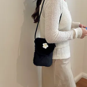 Trendy black plush crossbody phone bag for women, cute daisy flower detail, chic mini autumn purse.