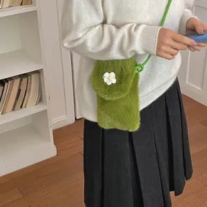 Green plush crossbody phone bag with cute white flower detail, perfect for autumn casual wear.