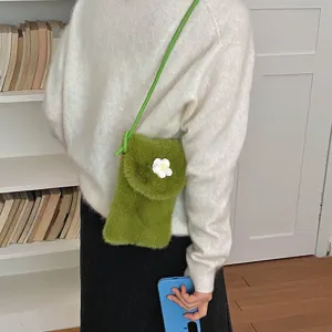 Chic green plush crossbody phone bag for women, cute floral detail, soft fluffy winter style.