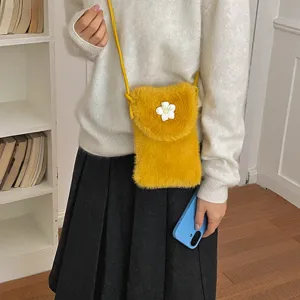 Close-up detail of the cute yellow plush crossbody phone bag with a sweet white flower.
