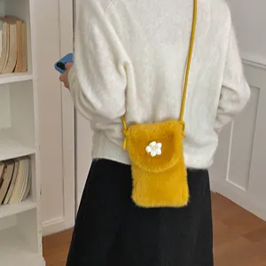 Stylish yellow plush phone crossbody bag for women, cute fluffy mini shoulder handbag.