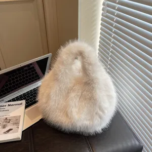 White fluffy plush handbag for women, cozy winter fashion tote bag with soft faux fur design.