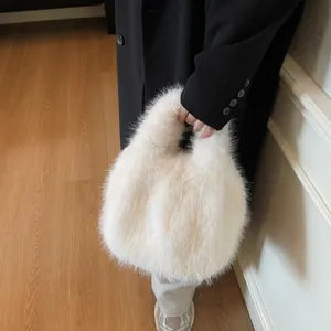 Close-up view of the soft white faux fur handbag detail, showing fluffy texture and handle.