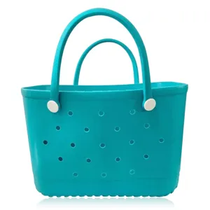 Detailed view of the turquoise rubber beach tote bag featuring durable handles and breathable holes.
