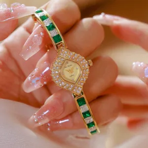Elegant women's vintage green gemstone quartz watch detail, luxury gold diamond bezel design.