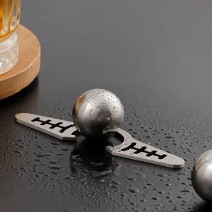Stainless steel coffee ice ball cooling set detail view on wet dark table surface.