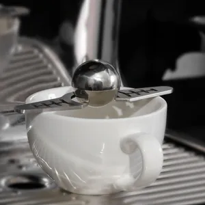 Stainless steel coffee ice ball tool detail closeup for espresso cooling and aroma.