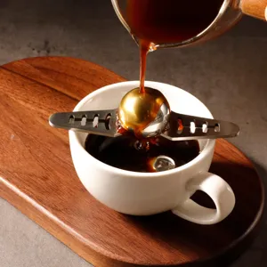 Stainless steel coffee ice ball maker with holder for espresso and pour over coffee aroma.