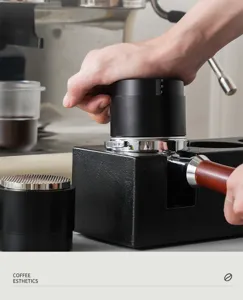 Coffee distributor and tamper tool detail view, adjustable depth black espresso accessory.