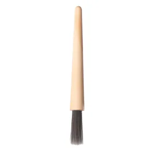 Coffee grinder cleaning brush with wooden handle and soft PBT bristles for baristas.