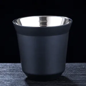 Double wall stainless steel cup detail, black matte exterior, polished interior metal.